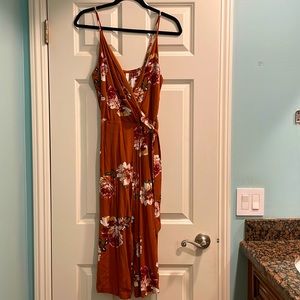 Spaghetti strap orange floral jumpsuit v-neck, mid-calf length pant, tie waist